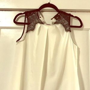 Black and white sleeveless blouse